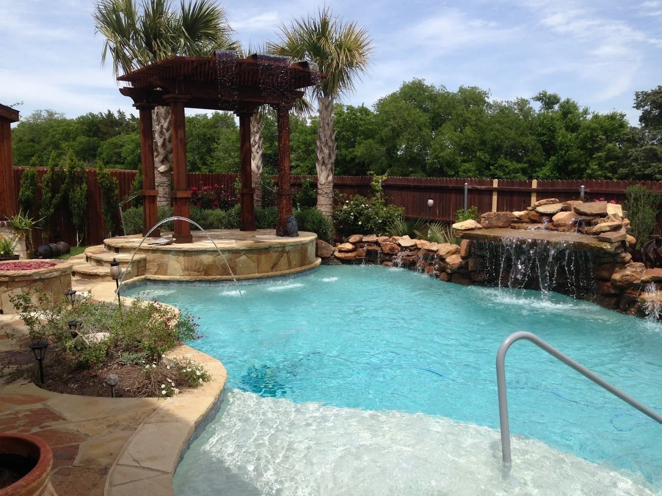 Backyard pool with gazebo and waterfall maintained by A&M Pool Service in Ellis County, Texas
