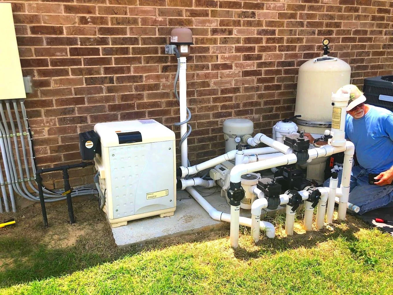 A&M Pool Service technician repairing pool pump equipment